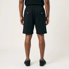 Black FJ033 Iconic Badge shorts, viewed from the back, featuring an elastic waistband and two snap-button pockets.