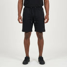 Black FJ033 Iconic Badge Shorts for men, featuring an adjustable drawstring waist, side zipper pockets, and a subtle iconic